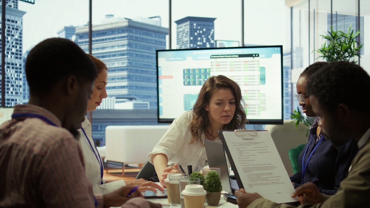 Team reviewing printed statistics in a meeting room