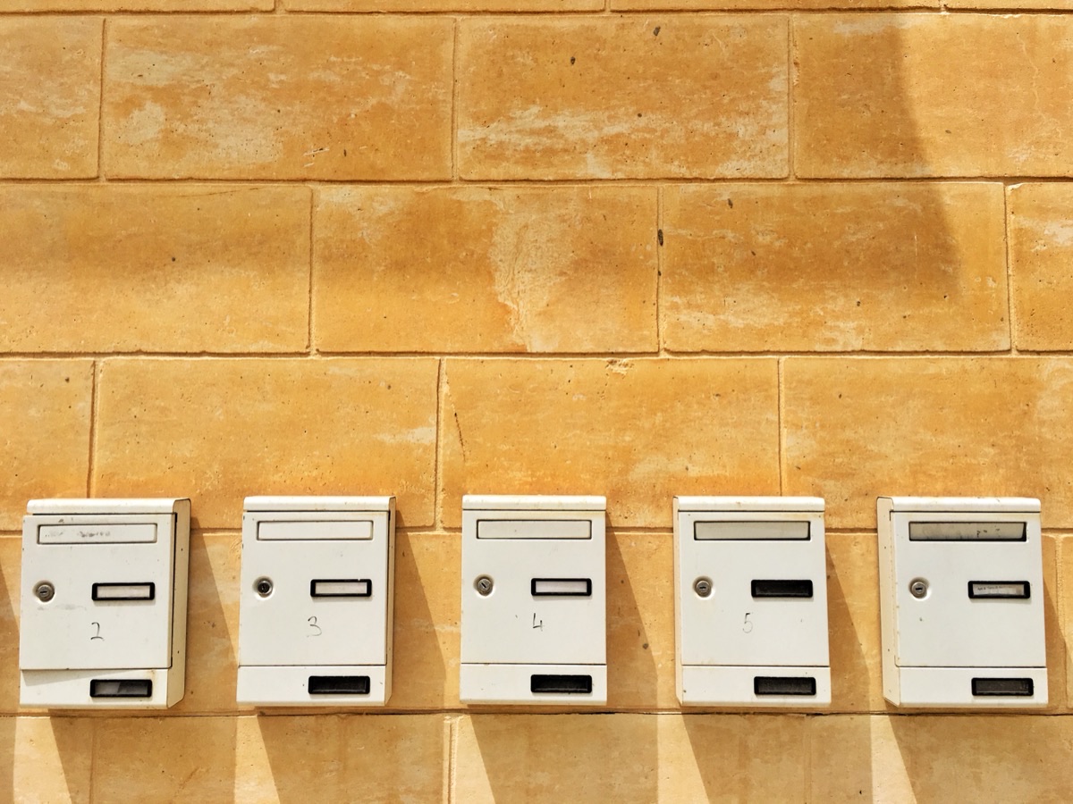Row of identical mailboxes on a wall