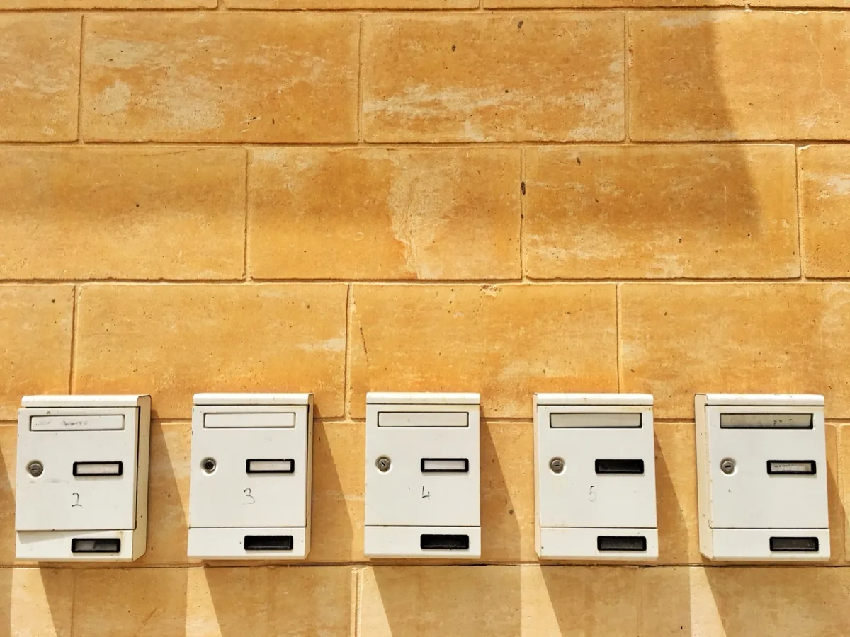 Row of identical mailboxes on a wall